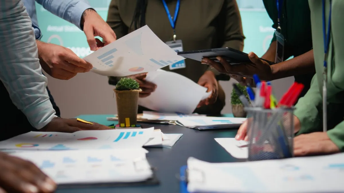 How to Get UPDA Certification in Qatar for Engineers – professionals discussing engineering documents and project plans in an office meeting.