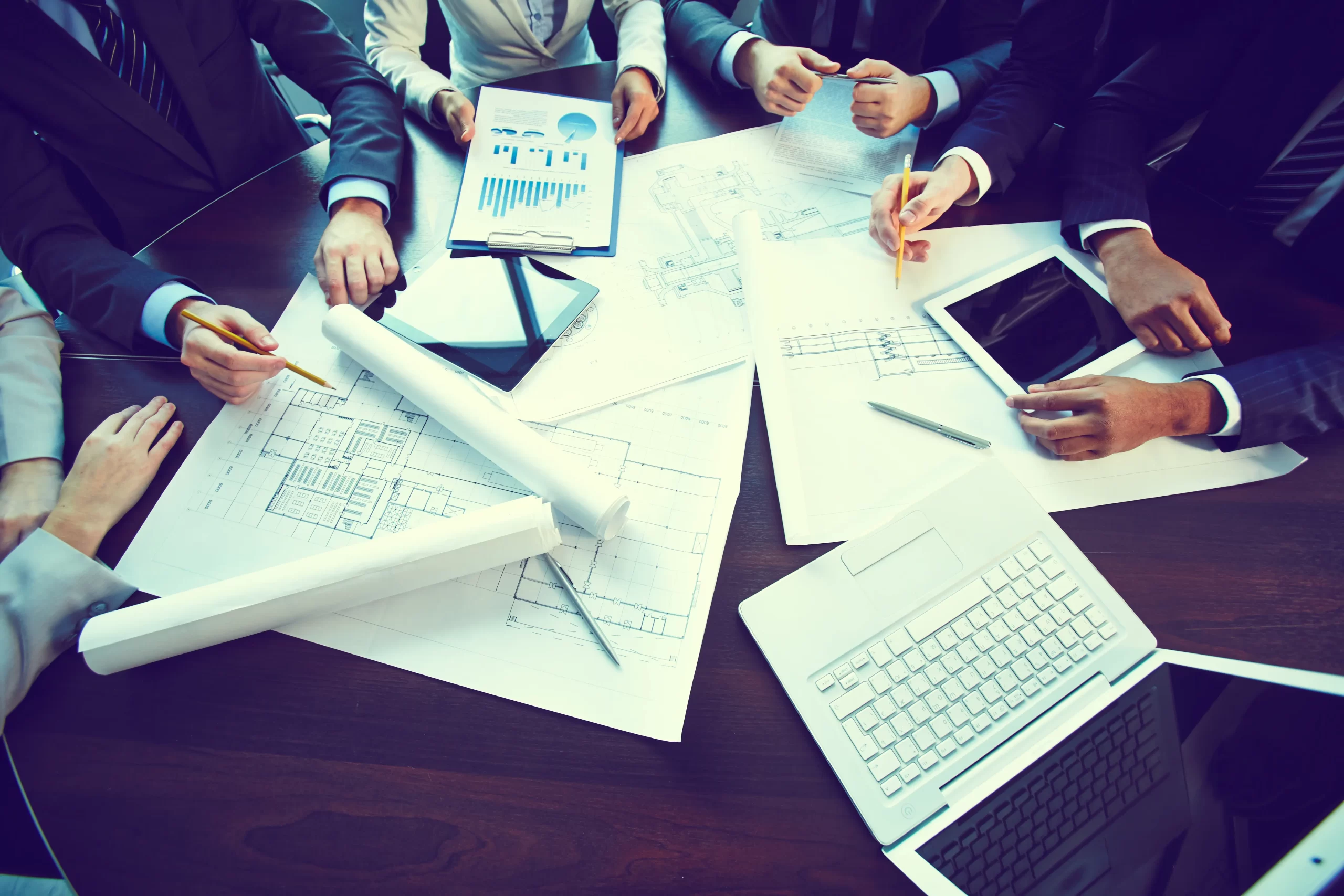Project management jobs in Qatar with professionals discussing construction and business plans